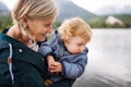Senior woman with little boy at the lake. Royalty Free Stock Photo