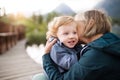 Senior woman with little boy at the lake. Royalty Free Stock Photo