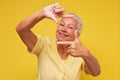 Senior woman looking at camera and gesturing finger frame Royalty Free Stock Photo
