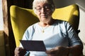 Senior woman looking at a photo Royalty Free Stock Photo