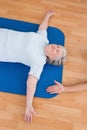 Senior woman lying on exercise mat Royalty Free Stock Photo