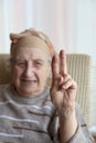 Senior woman making victory sign Royalty Free Stock Photo