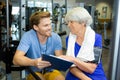 senior woman with male personal trainer exercising in gym Royalty Free Stock Photo