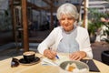 Senior woman with map and coffee at street cafe Royalty Free Stock Photo