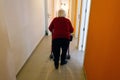 Senior woman with her walker inside the corridors of her nursing home in Mallorca Royalty Free Stock Photo