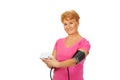 Senior woman measuring blood pressure with automatic manometer Royalty Free Stock Photo