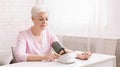 Senior woman measuring her blood pressure at home. Royalty Free Stock Photo