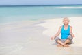 Senior Woman Meditating On Beautiful Beach Royalty Free Stock Photo