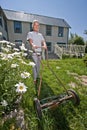 Senior woman mowing lawn Royalty Free Stock Photo