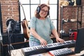 Senior woman musician playing piano keyboard at music studio Royalty Free Stock Photo