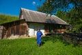 Senior woman near old wooden house