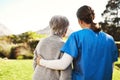 Senior woman, nurse and hug in healthcare, life insurance or support together in nature. back view of mature female with Royalty Free Stock Photo