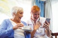 Senior woman and nurse using digital tablet