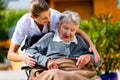 Senior woman in nursing home with nurse in garden Royalty Free Stock Photo