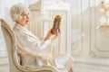 Senior woman observing old photo of her youth