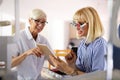 Senior woman optometrist examining patient in modern ophthalmology clinic Royalty Free Stock Photo