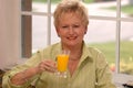 Senior woman with orange juice Royalty Free Stock Photo