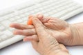 Senior woman painful finger due to use of keyboard