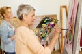 Senior woman painting at art school studio Royalty Free Stock Photo