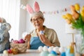 Senior woman painting eggs Royalty Free Stock Photo