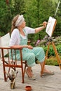 Senior woman painting outdoors Royalty Free Stock Photo