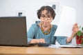 Senior woman paying bills with laptop at home Royalty Free Stock Photo