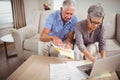 Senior woman paying bills online on laptop Royalty Free Stock Photo