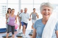 Senior woman with people exercising in fitness studio Royalty Free Stock Photo