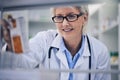 Senior woman, pharmacist and reading medication on shelf for inventory, diagnosis or prescription at pharmacy. Happy Royalty Free Stock Photo