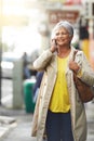 Senior woman, phone call and smile for walk and relax in city for free time or travel on sidewalk for fashion, retired Royalty Free Stock Photo