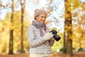 Senior woman with photo camera at autumn park Royalty Free Stock Photo