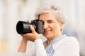 Senior woman photographing by digital camera Royalty Free Stock Photo