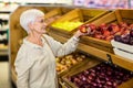 Senior woman picking out red apple Royalty Free Stock Photo