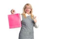 Mature woman with a pink package raise her thumb up Royalty Free Stock Photo