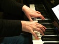 Senior woman playing piano. Close up side view of elderly hands and fingers playing a song Royalty Free Stock Photo
