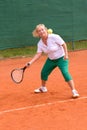 Senior woman playing tennis Royalty Free Stock Photo