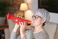 Senior woman playing a trumpet Royalty Free Stock Photo