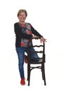 Senior woman playing wiyh chair on white Royalty Free Stock Photo