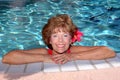 Senior woman by the pool Royalty Free Stock Photo