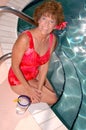 Senior woman by the pool Royalty Free Stock Photo