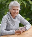 Senior woman, portrait and outdoors playing cards, happy and game of bridge at park, garden or backyard. Elderly female Royalty Free Stock Photo