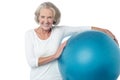 Senior woman posing with exercise ball