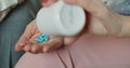 Senior woman pouring painkiller pills on a hand from a bottle of medicine. Old elderly grandmother health care, pharmacy Royalty Free Stock Photo