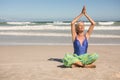 Senior woman practising yoga while sitting against clear sky Royalty Free Stock Photo