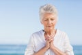 Senior woman praying on the beach Royalty Free Stock Photo