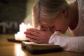 Senior woman praying, hands clasped together on her Bible. Royalty Free Stock Photo