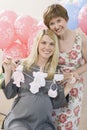 Senior Woman And Pregnant Daughter At A Baby Shower