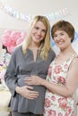 Senior Woman And Pregnant Daughter Smiling