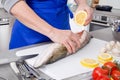 Senior woman preparing fish in kitchen Royalty Free Stock Photo