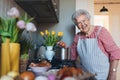 Senior woman preparing traditional easter meals for family, boiling eggs. Recreating family traditions and customs.